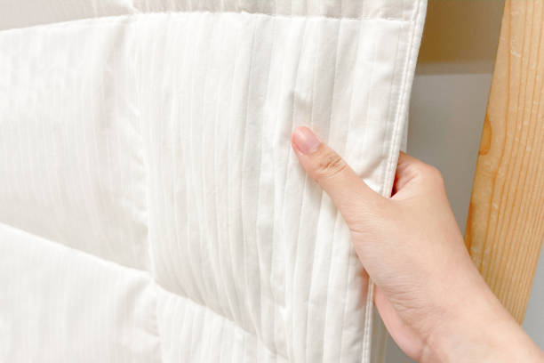 istock woman hand touch soft white fabric 1295063921