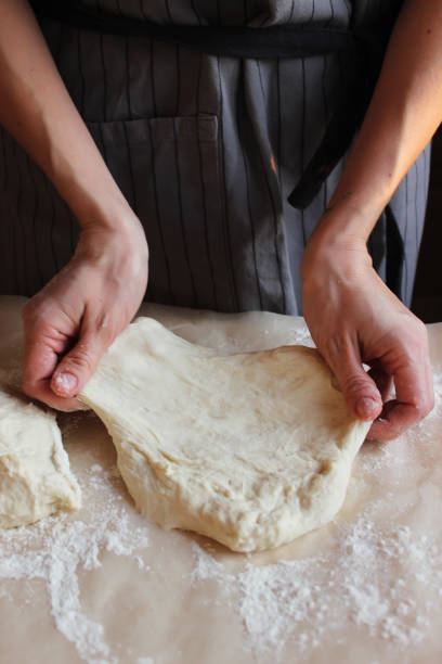 istock Household. A woman's hands form the dough for baking. Family celebration. 1295064291