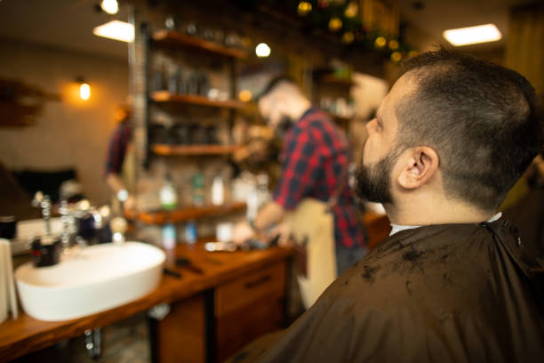 istock Man at barber shop getting beard care treatment 1295065081