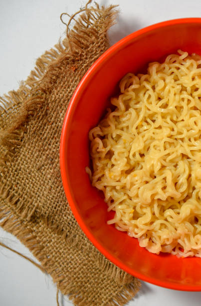 istock Instant noodles in bowl isolated on white background, top view 1295065135