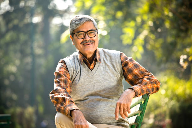 Senior man sitting at park bench