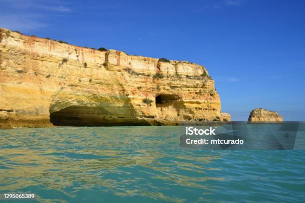 Cliff With Cave And Sea Stack In The Horizon Praia Da Marinha Lagoa Algarve Portugal Stock Photo - Download Image Now