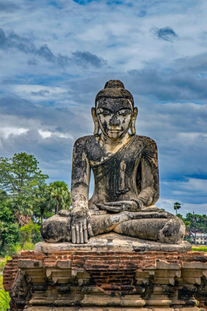 istock Buddhism temple ruin with Buddha Statue 1295066319