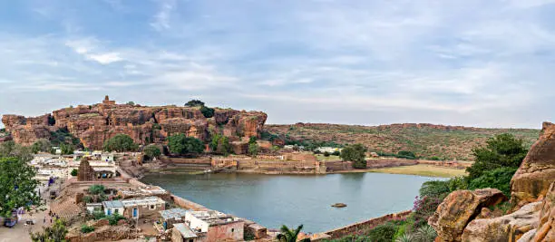 Photo of Panorama image of Lake near natural stone caves in Badami, Karnataka, India.