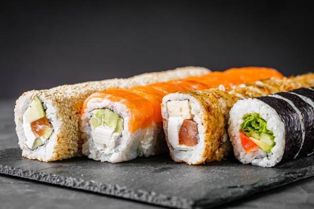 istock appetizing set of sushi roll on a black stone plate 1295068996