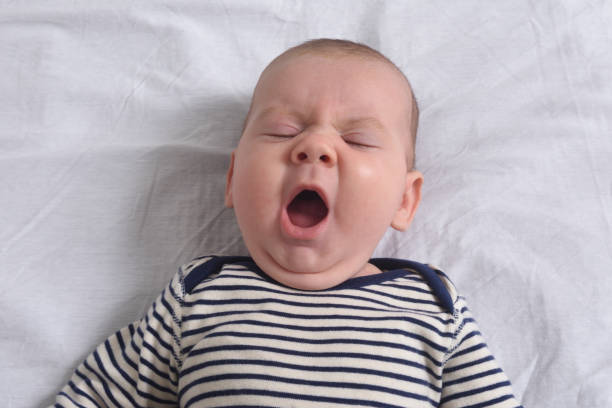 istock relaxed baby yawning 1295069368