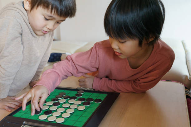A Japanese child is playing game in the house