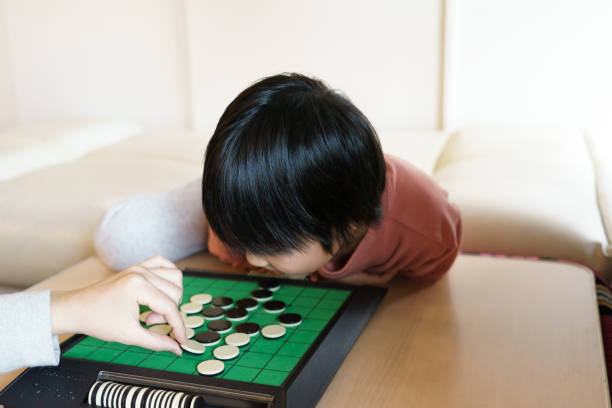 istock A Japanese child is playing game in the house 1295069455
