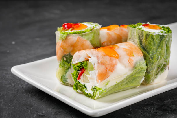 istock appetizing spring rolls with sea food and philadelphia cheese on a darck background 1295070148