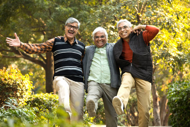 istock Senior male friends having fun at park 1295071373