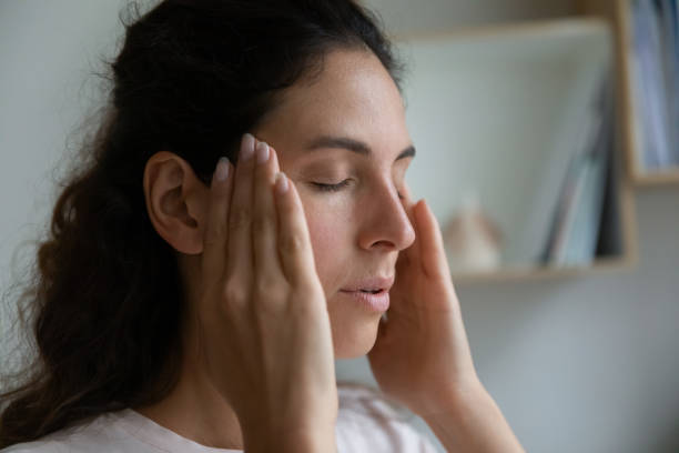 istock Close up upset woman touching temples, suffering from headache 1295072576