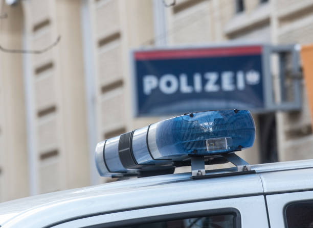 Blue light on the roof of a police car Blue light on the roof of a police car, police station (Polizei) sign blurred in the background austria stock pictures, royalty-free photos & images