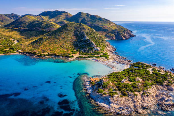 istock Cost of Sardinia: Peninsula of Punta Molentis. View of beautiful beach at Punta Molentis, Villasimius, Sardinia, Italy. Beautiful bay with sandy beach at Punta Molentis, Sardinia island, Italy. 1295073782