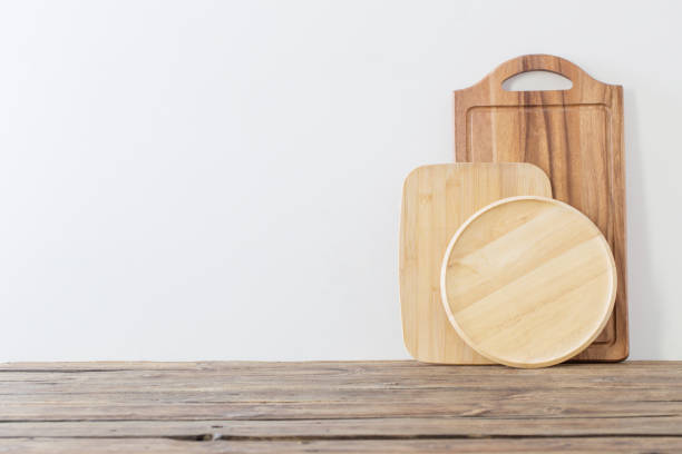istock cutting board on wooden table on background white wall 1295074678