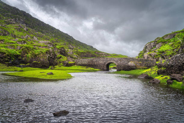 piccolo ponte dei desideri in pietra sul lago a gap of dunloe - macgillicuddys reeks foto e immagini stock