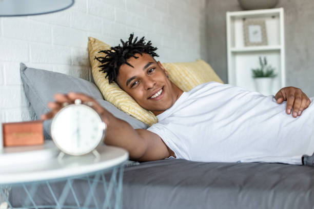 istock Young man waking up in the morning and feeling happy 1295076081