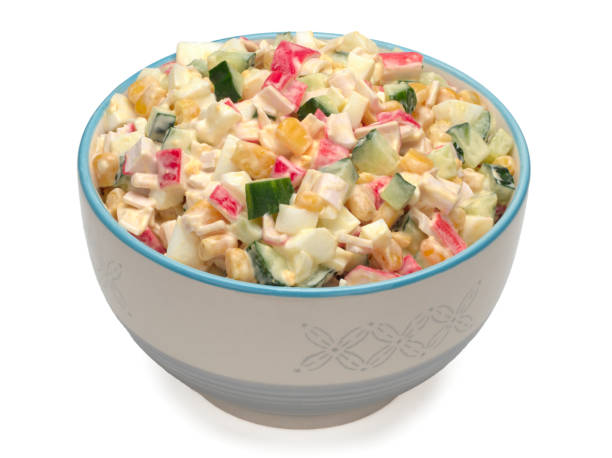 istock Salad with corn, crab sticks, cucumbers, eggs and mayonnaise in a bowl 1295078120
