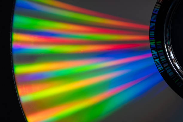 istock multi coloured rays of light shining on a DVD 1295078634