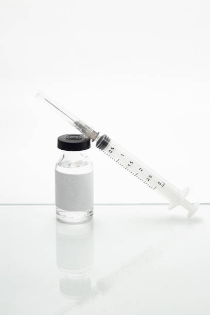 istock Vaccine glass and a syringe. 1295079261