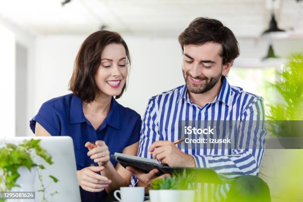 Coworkers Working In The Ecofriendly Green Office Stock Photo - Download Image Now - 30-39 Years, Adult, Adults Only