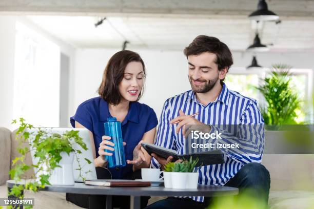 Coworkers Working In The Ecofriendly Green Office Stock Photo - Download Image Now - Men, New Business, Sofa