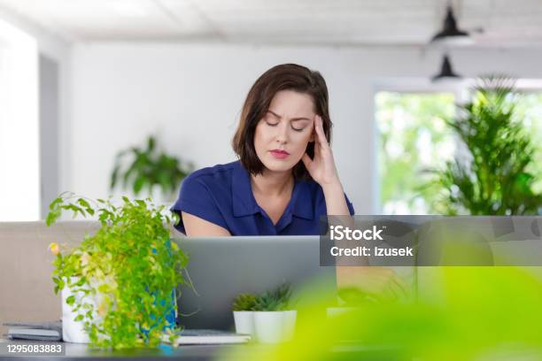 Tired Woman Working On Laptop At Home Stock Photo - Download Image Now - Green Color, Headache, Tired