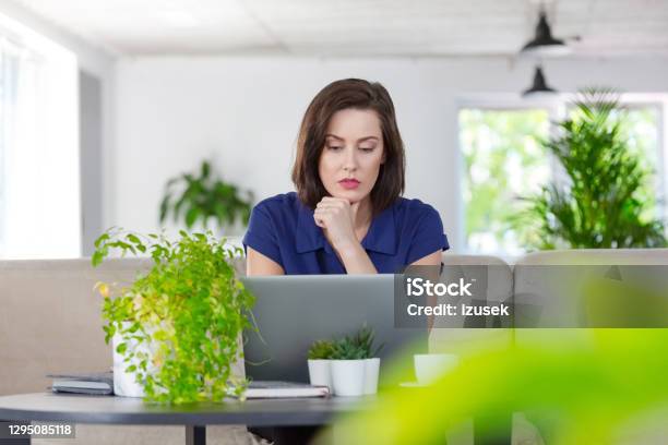 Worried Woman Working On Laptop At Home Stock Photo - Download Image Now - Blue, Laptop, Worried