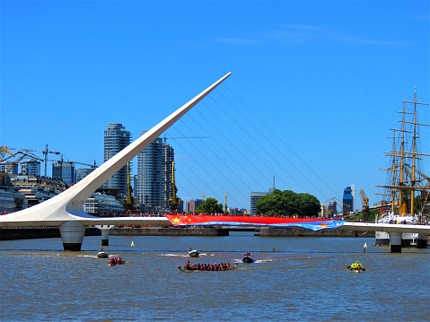 Buenos Aires, Argentina - January 26, 2020. Cityscape of Puerto Madero .The Chinese New Year celebration in Buenos Aires city. Dragon boats racing in the Rio de la Plata as part of the celebrations for the chinese new year 4717 The Woman´s Bridge with argentinian and chinese flags at the Puerto The Woman´s Bridge ( Puente de la Mujer ) designed by the Spanish architect Santiago Calatrava. .