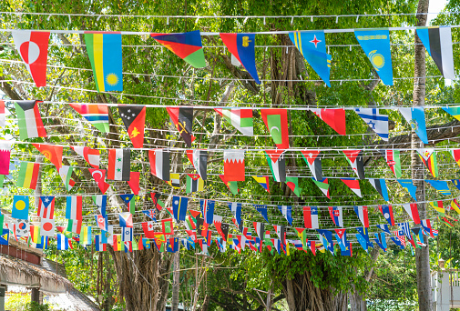 Stretched ropes, ribbons, with flags of different countries. Thailand