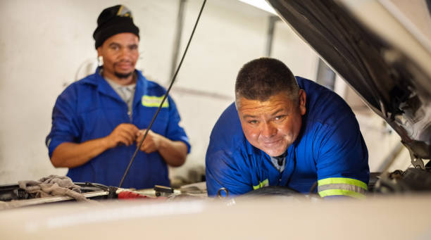 istock Car mechanic working in garage 1295089541