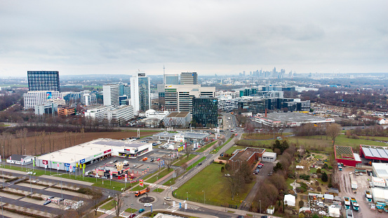 Eschborn, Germany - January 7, 2021: Aerial view of business park and commercial area of Eschborn, Germany. Due to its proximity to the financial district of Frankfurt and a relatively low business tax rate Eschborn is home to many international large corporations