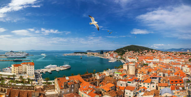 istock Split waterfront and Marjan hill aerial view, Dalmatia, Croatia. Panoramic summer cityscape of old medieval city Split, Croatia, Europe.  Traveling concept background. Seagull's flying over Split. 1295092409
