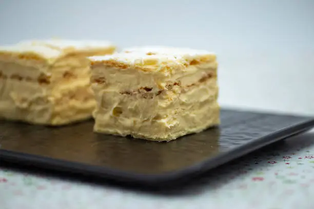 Cream pie with layers of puff pastry in ceramic plat