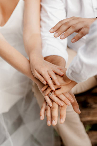 istock the bride and groom tenderly hold hands between them love and relationships 1295093349