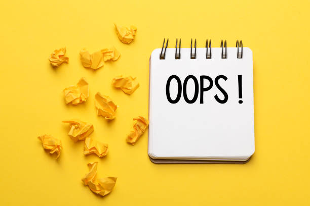 istock The words Oops with a black marker in a notebook on a yellow background .. Apologies for a minor accident or mistake. 1295097026