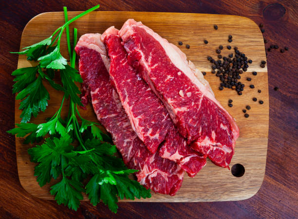 istock Raw beef tenderloin with spices on cutting board 1295098935