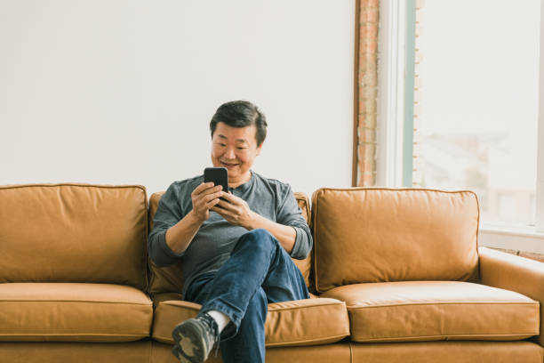 istock Confident man video chats with family 1295099801