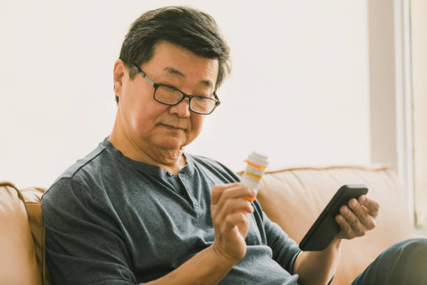 istock Senior man reads instructions on medication label 1295099810