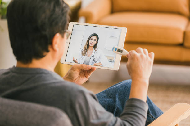 istock Man discusses fever with doctor 1295099839