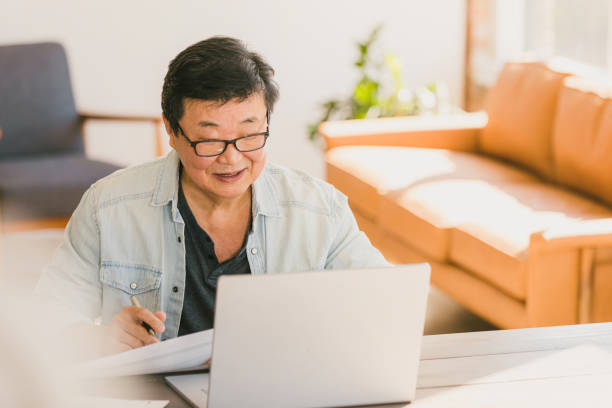 istock Senior man works on home finances 1295099869