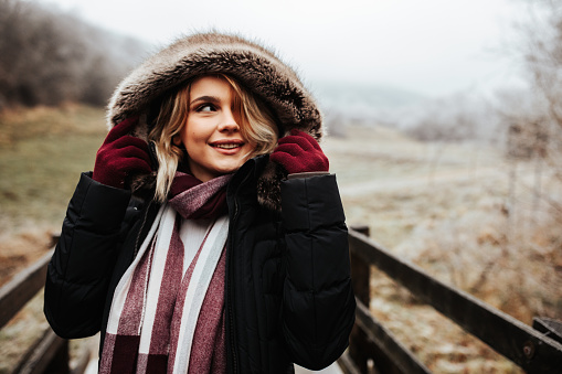 Young blonde haired female enjoying a cold winter walk