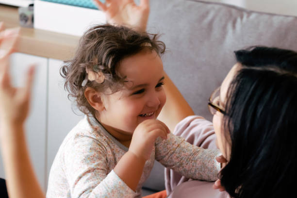 istock Happy small daughter having fun with her mother at home. 1295101752