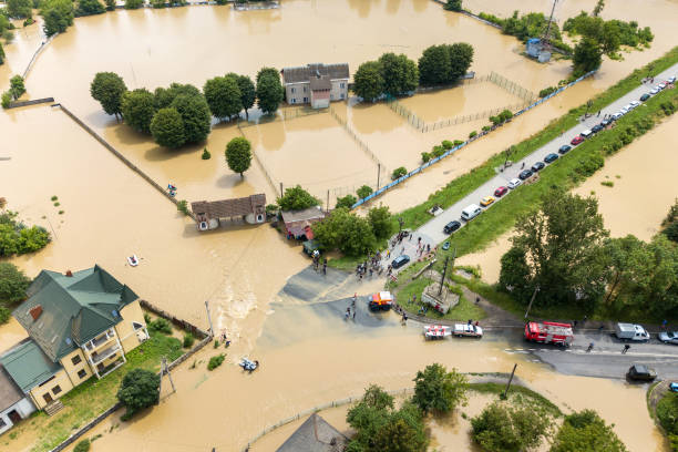 Aerial view of flooded houses and rescue vehicles saving people in Halych town, western Ukraine. Aerial view of flooded houses and rescue vehicles saving people in Halych town, western Ukraine. flushing water stock pictures, royalty-free photos & images