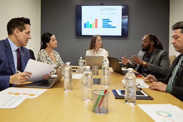 istock Multi-Ethnic Group of Businesspeople Working in Board Room 1295109028