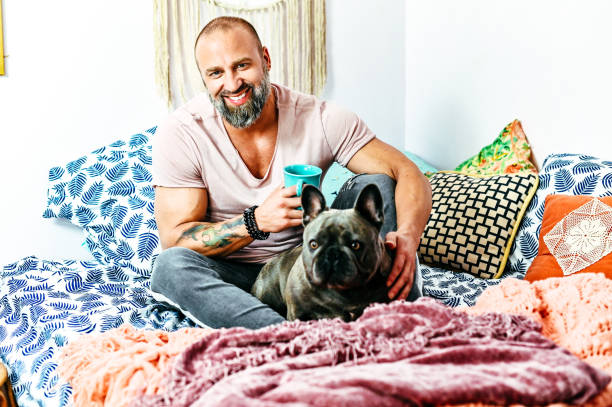 istock Happy man relaxes at home with his pet dog 1295112365