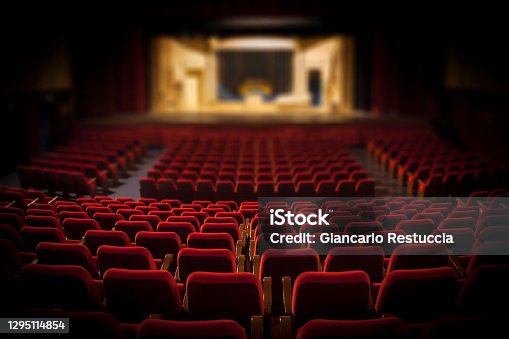 istock Empty red armchairs of a theater ready for a show 1295114854