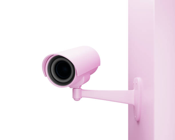istock Pink CCTV security camera on the wall isolated on white, 3d render 1295115108