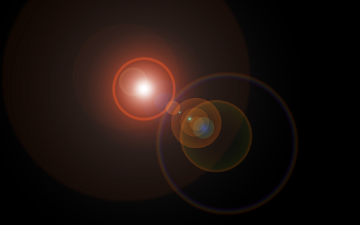Destello de lente que parece esferas cósmicas multicolores de luz y luz reflejada en varios tamaños centrado fondo negro photo