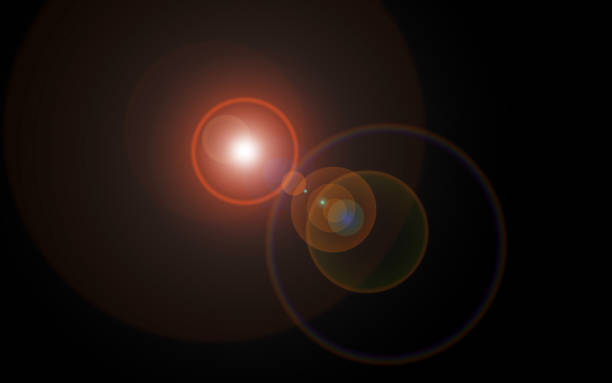 destello de lente que parece esferas cósmicas multicolores de luz y luz reflejada en varios tamaños centrado fondo negro - lens flare fotografías e imágenes de stock