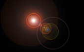Lens flare looking like multi-colored cosmic spheres of light and reflected light in various sizes centered black background